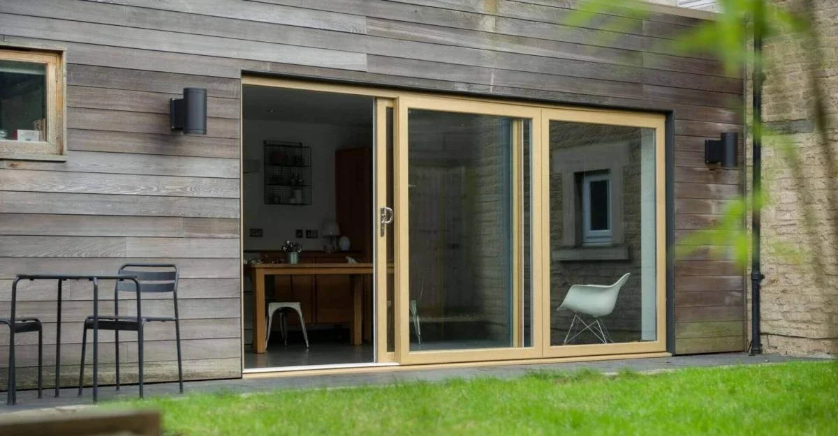 Wood-effect uPVC sliding patio doors opening onto a garden deck