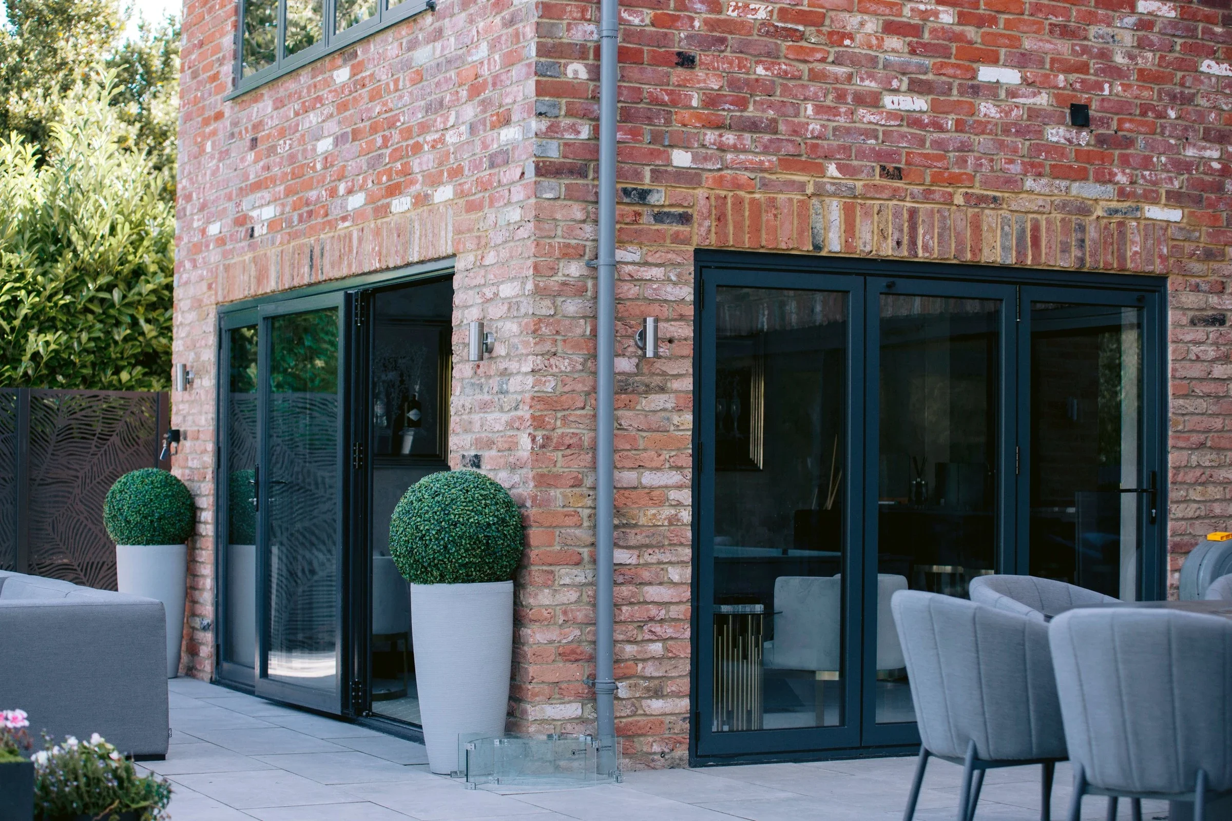 Brick house with large aluminium bi-folding doors