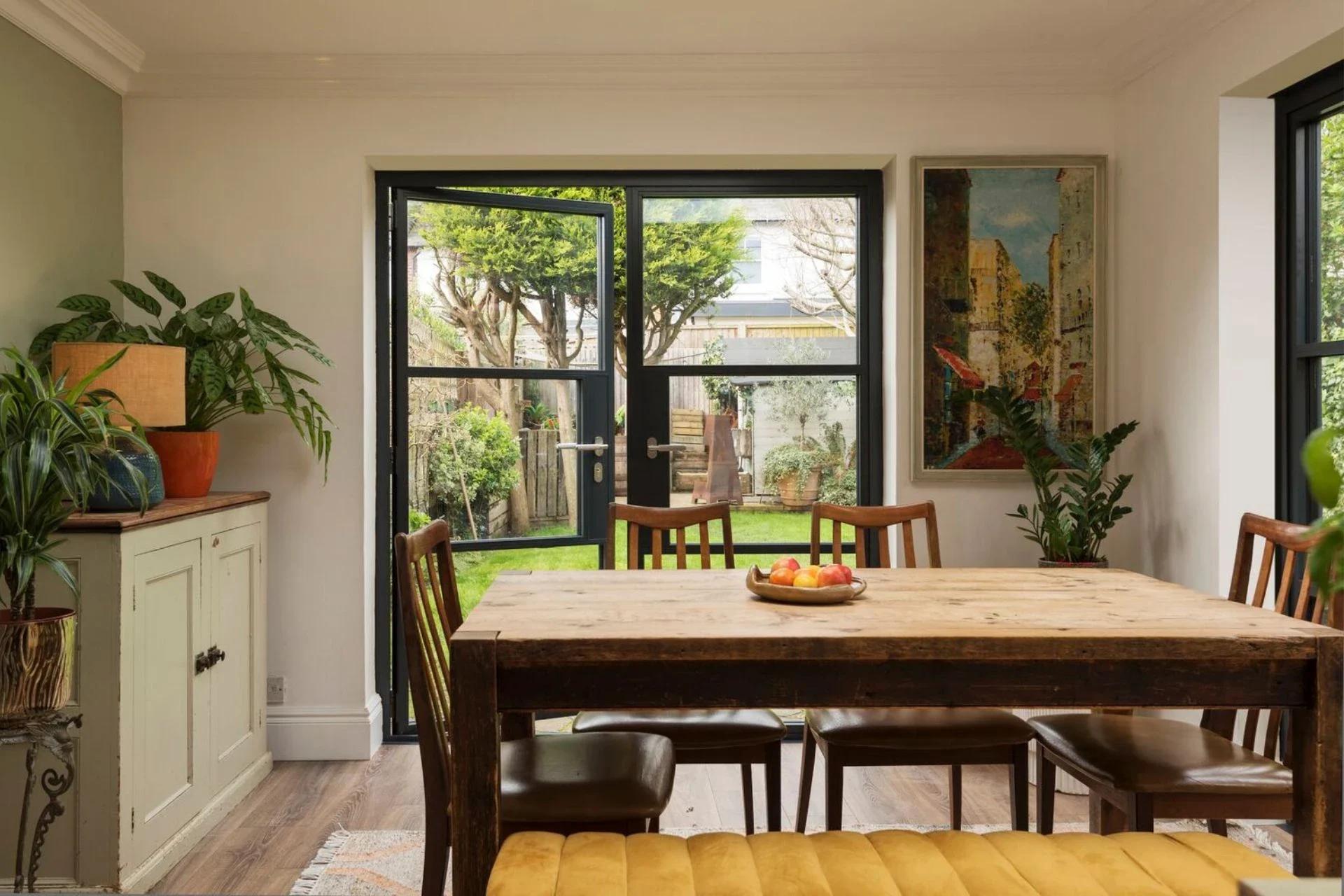 Heritage aluminium French doors beside a timber dining table