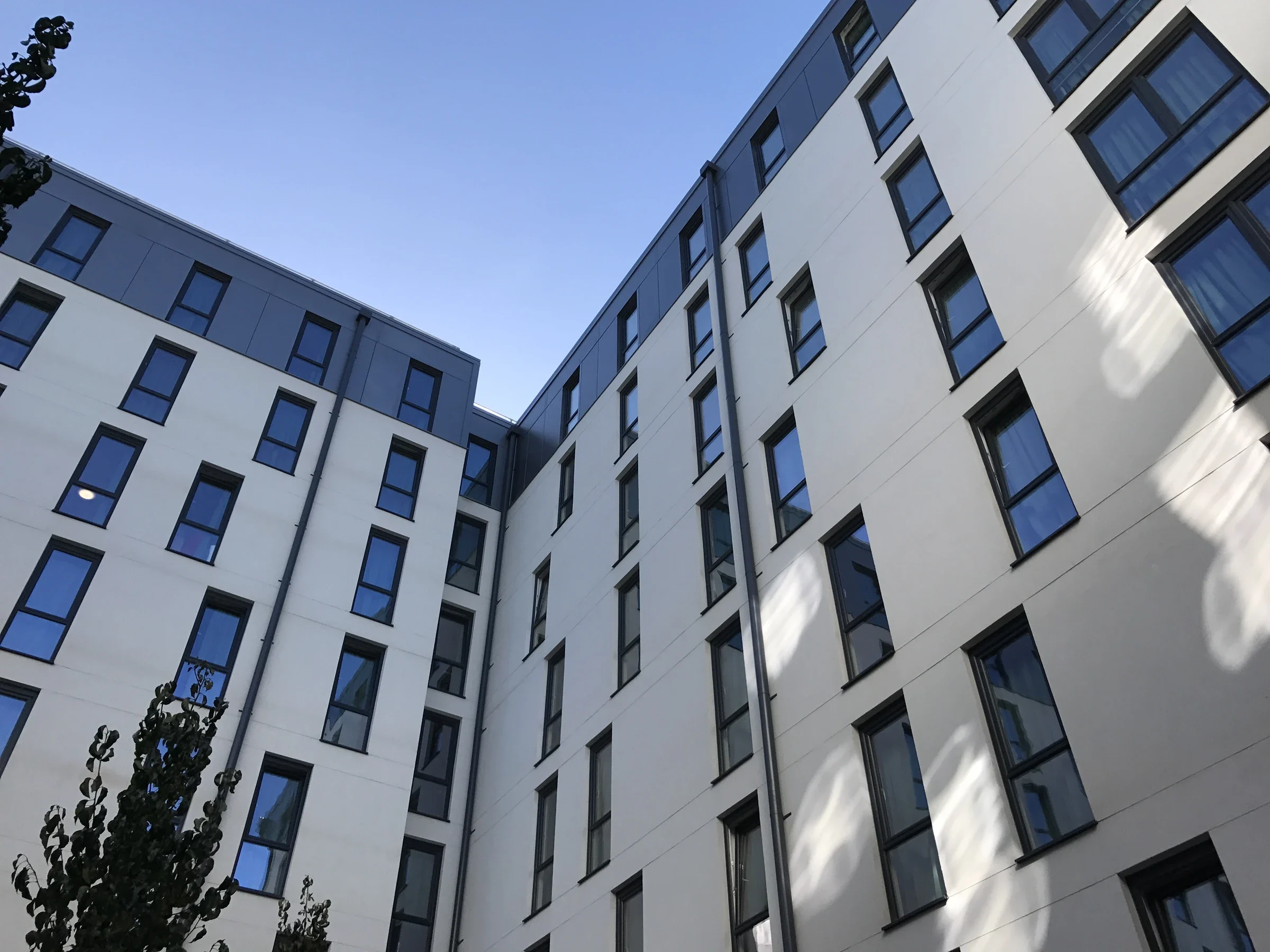 Grey uPVC tilt-and-turn windows across the elevations of an apartment development