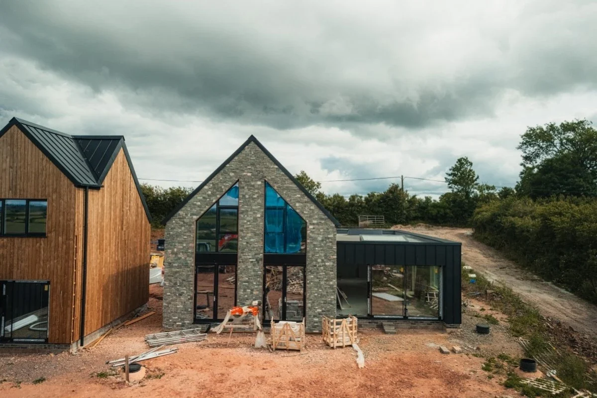 Slimline sliding doors installed in a stone and timber-clad property