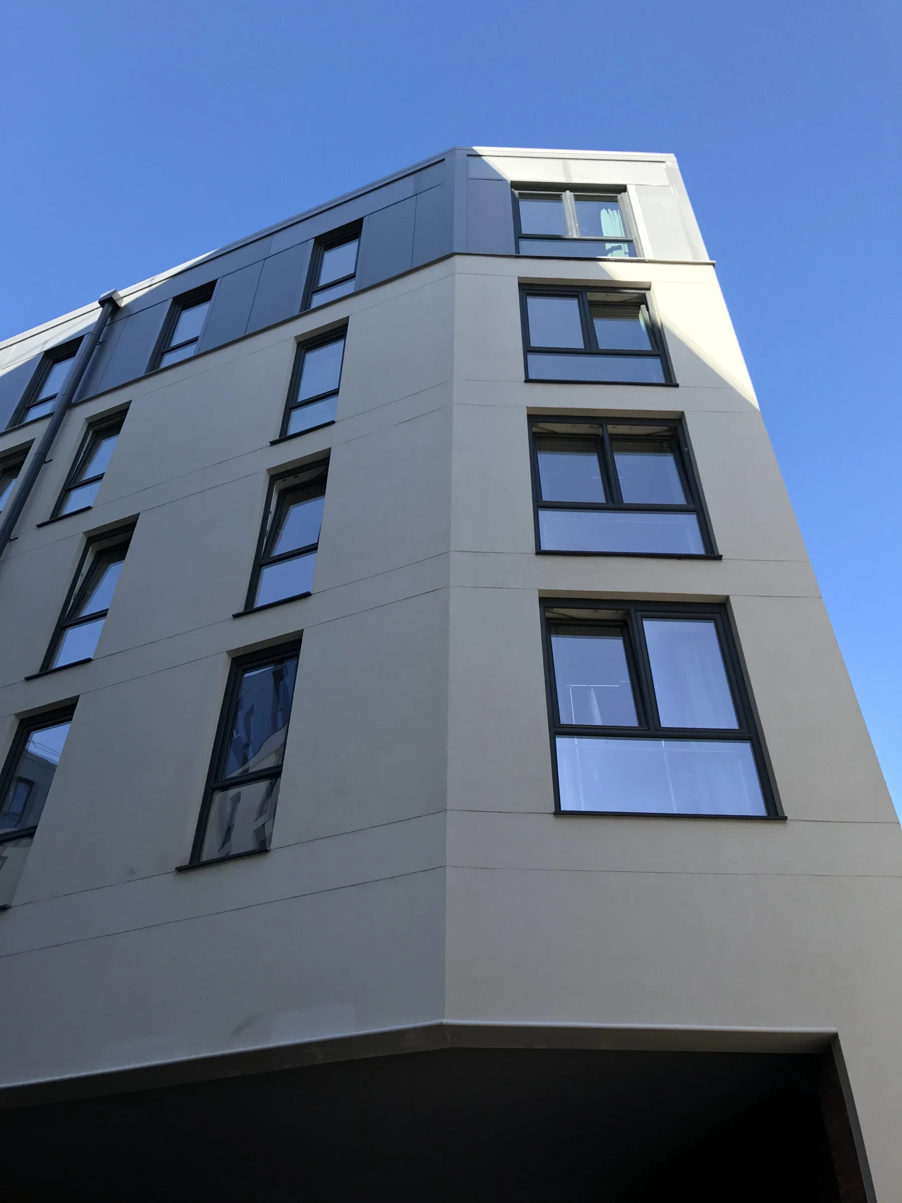 Grey uPVC tilt-and-turn windows on a modern apartment building