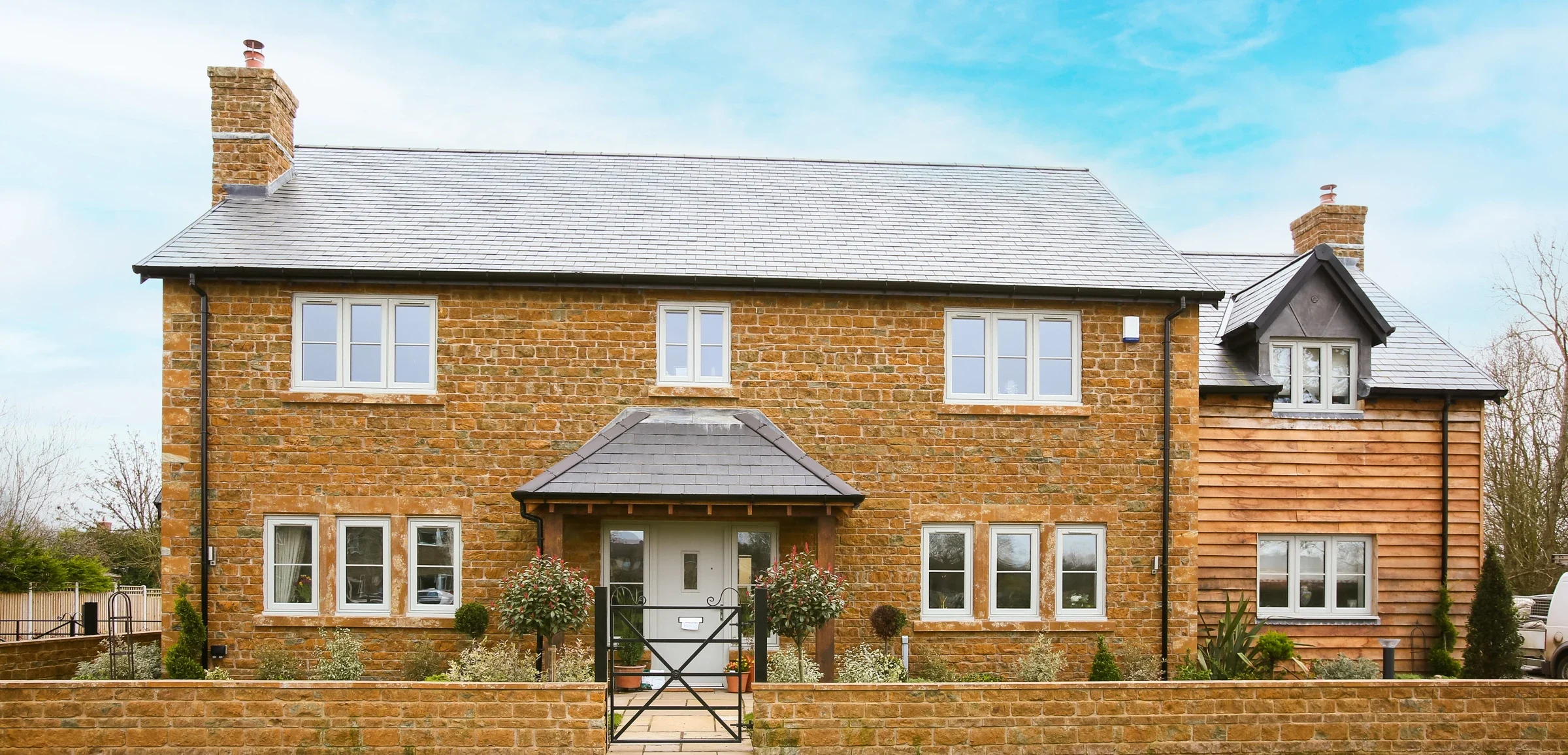 Pale grey uPVC flush windows on a stone-built country house