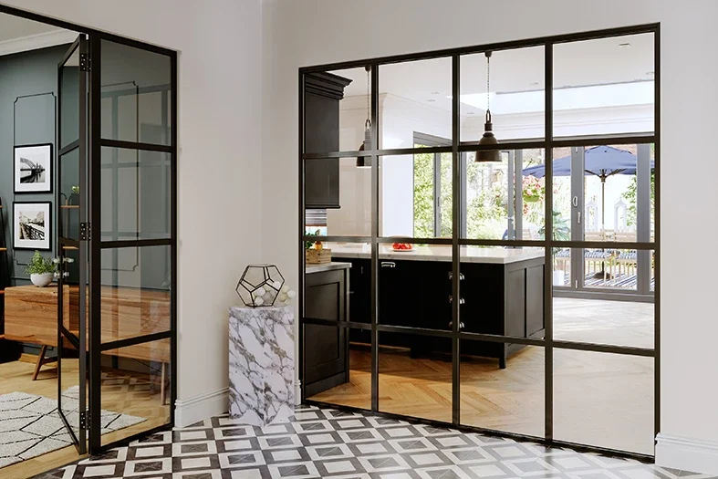 Black aluminium screen and door dividing a hallway and kitchen