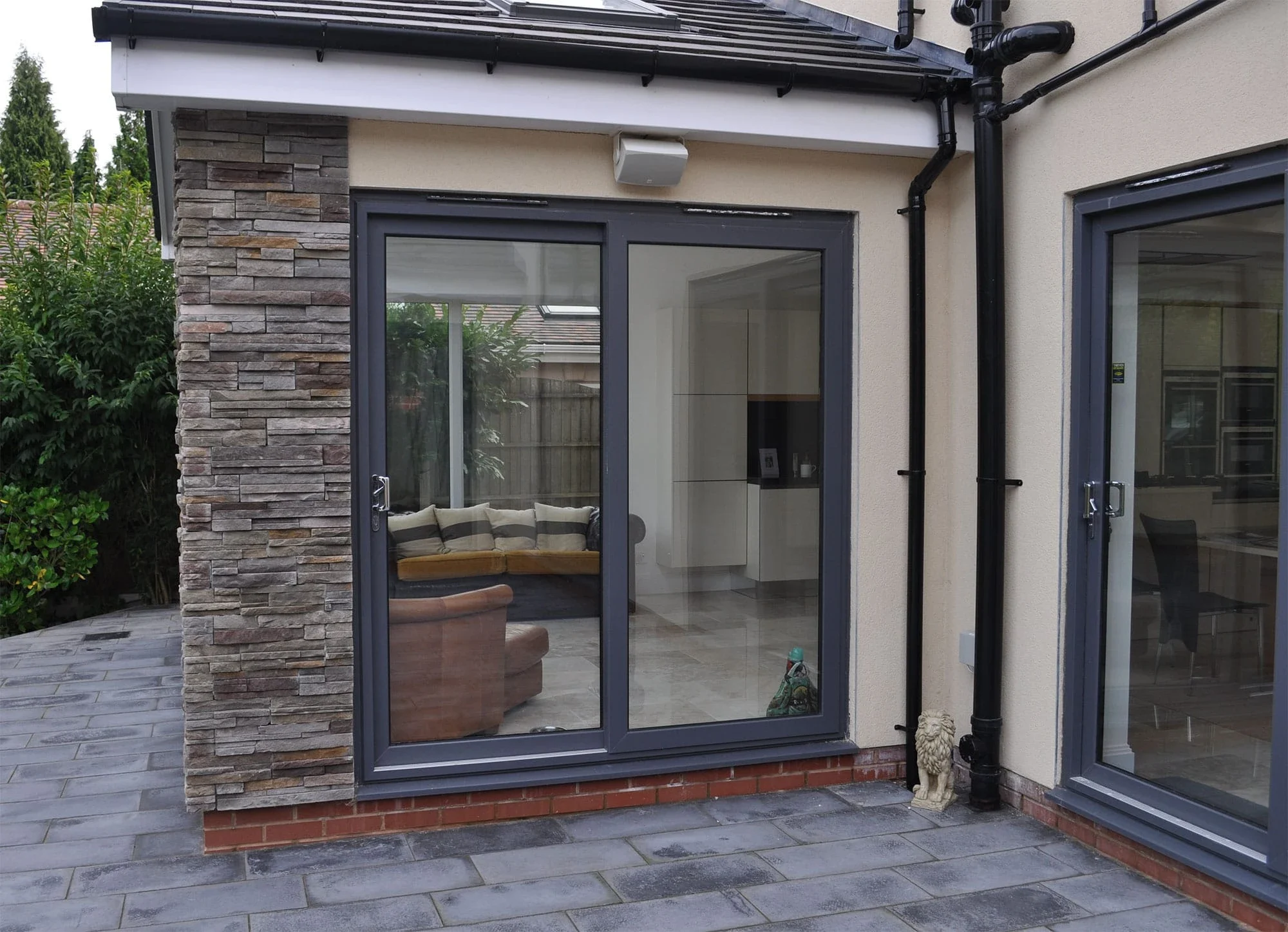 Grey uPVC sliding patio doors opening onto a garden