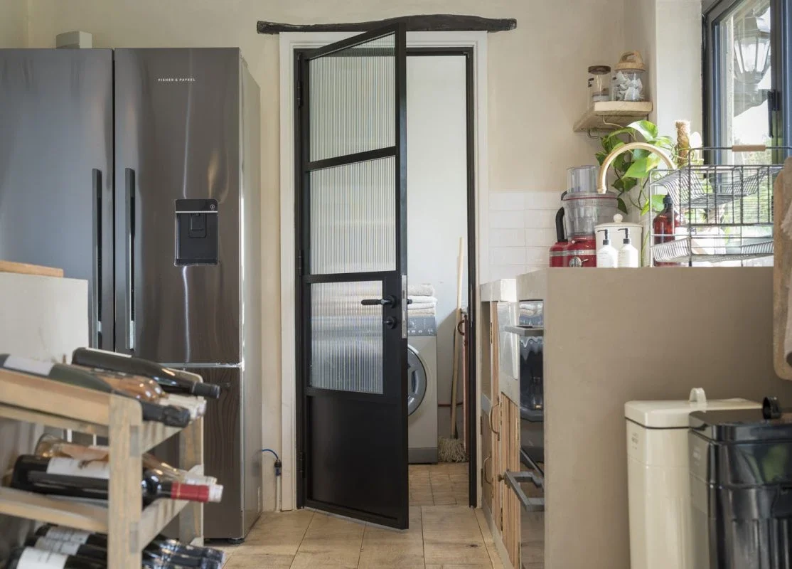 Black internal aluminium single door between a kitchen and dining space