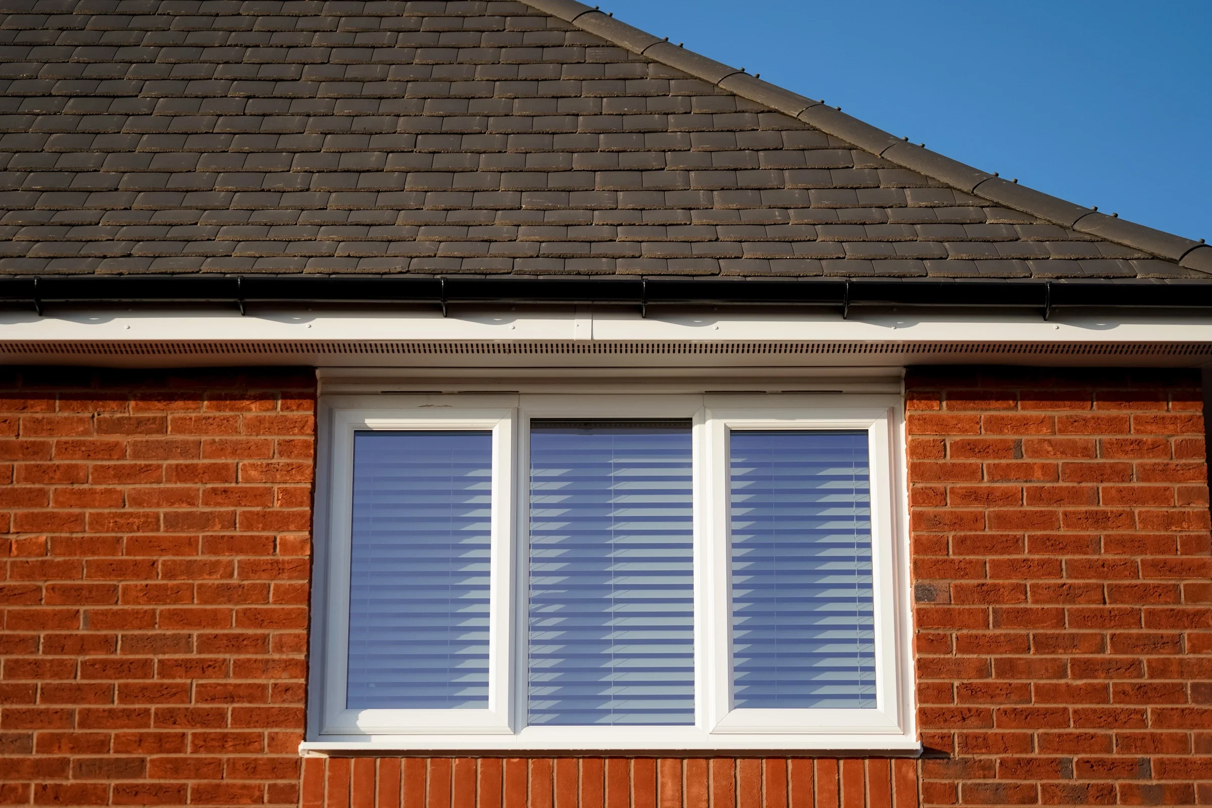 White uPVC casement window in a brick bungalow