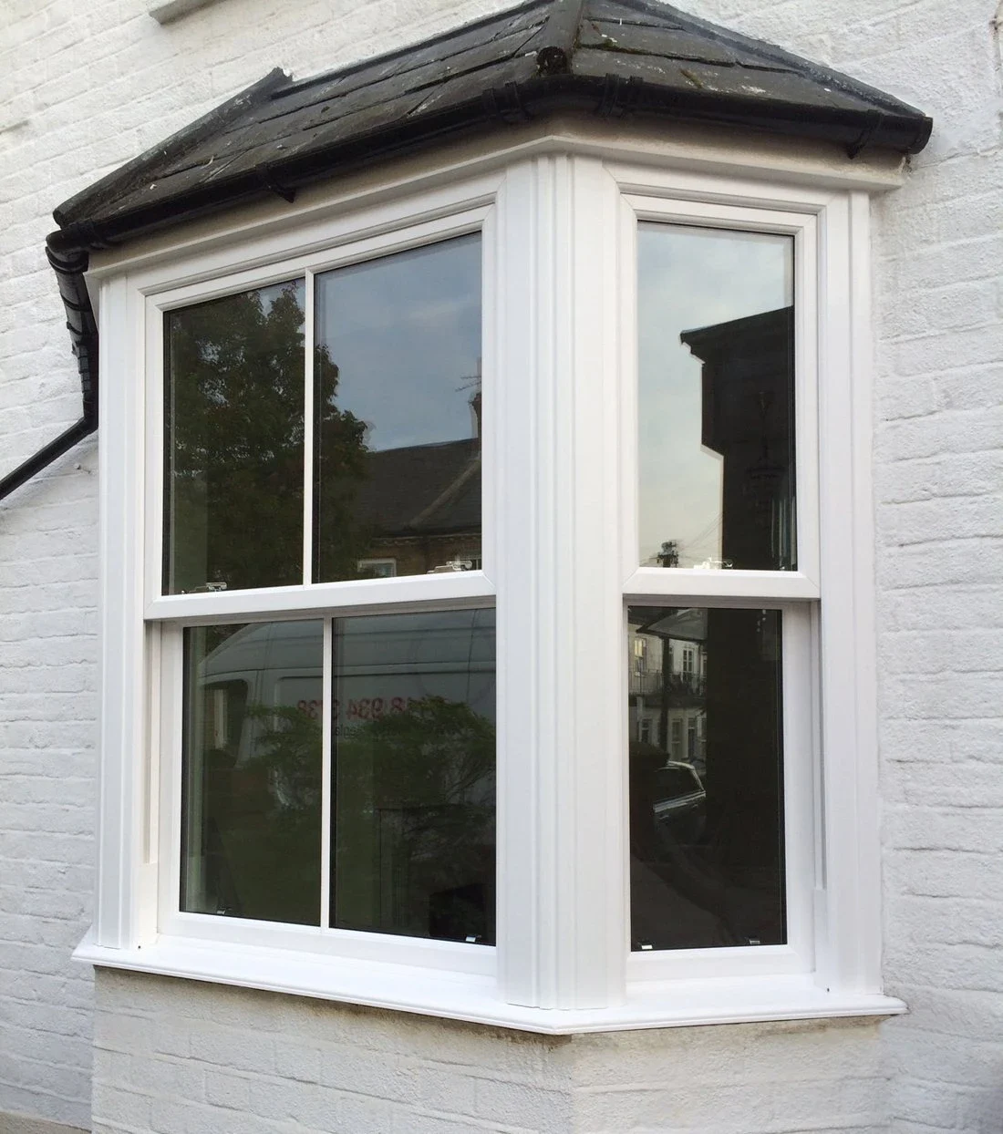 White uPVC sliding sash bay window