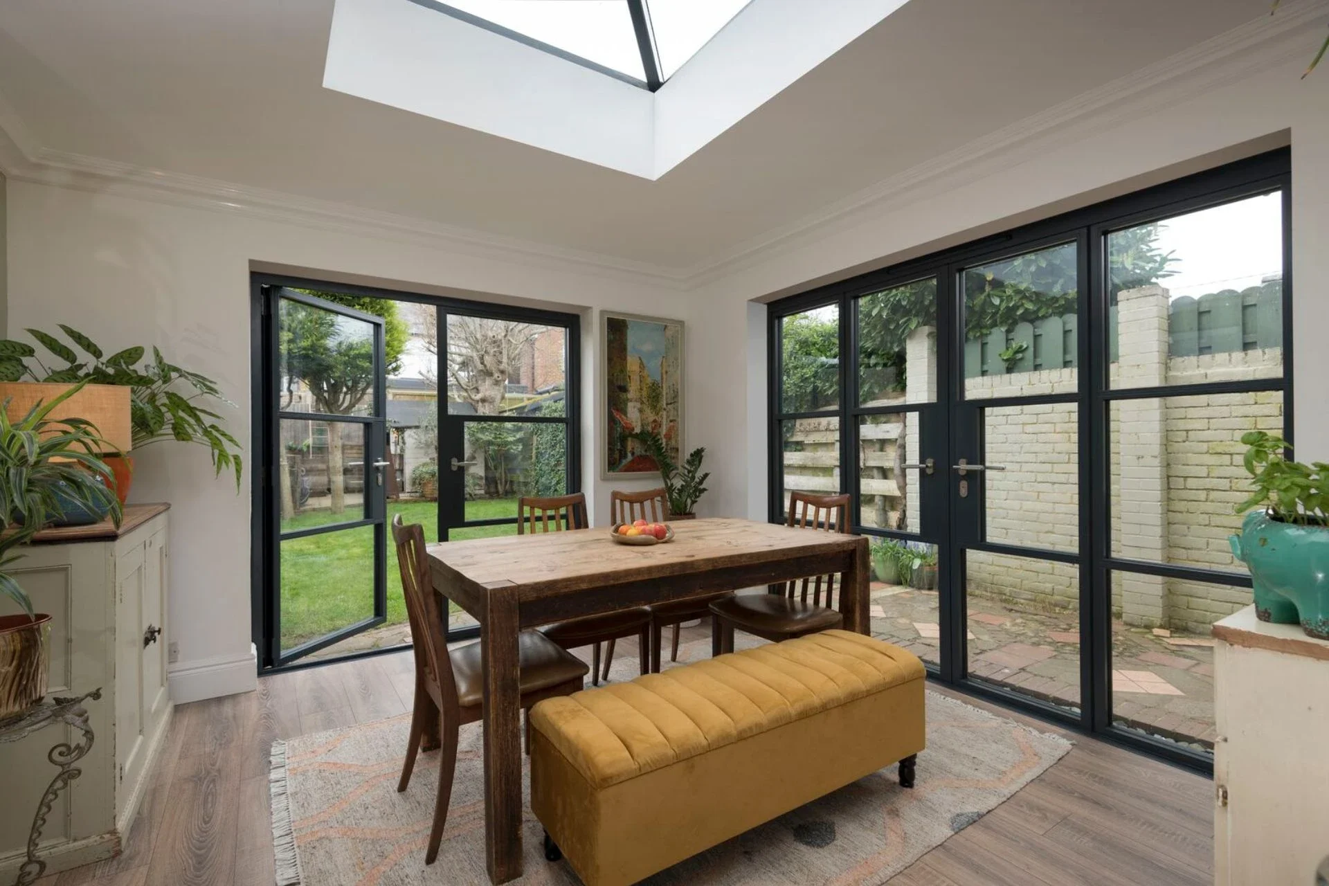 Black aluminium French doors surrounding a dining area