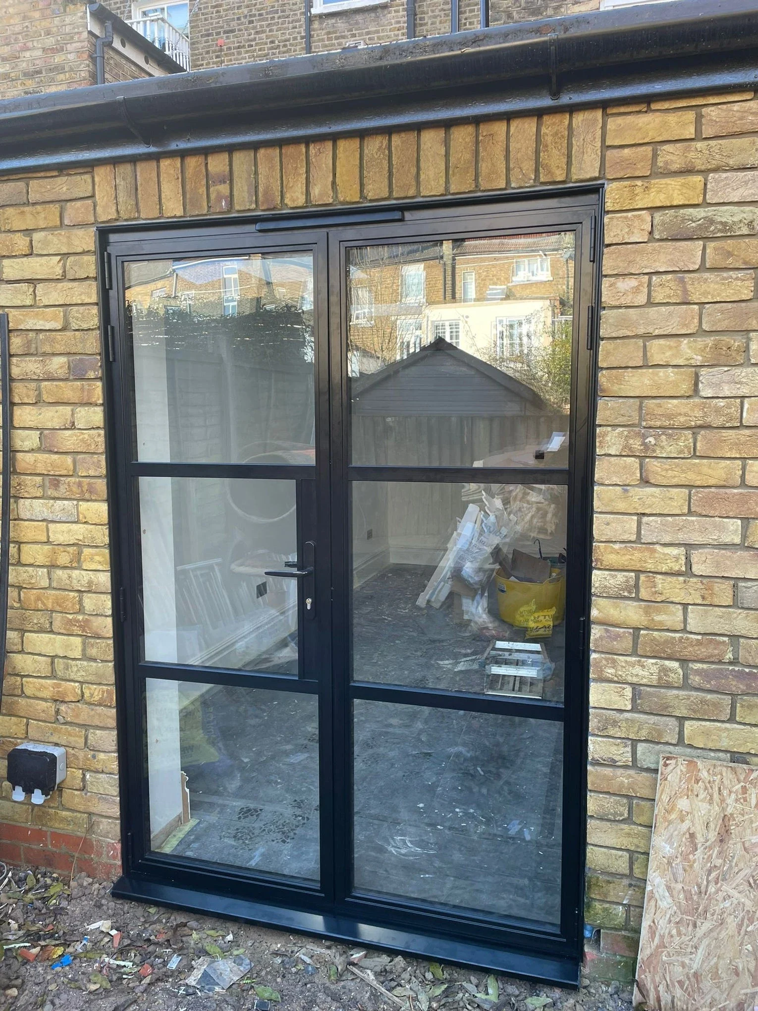 Grey heritage aluminium single door with a glazed fanlight