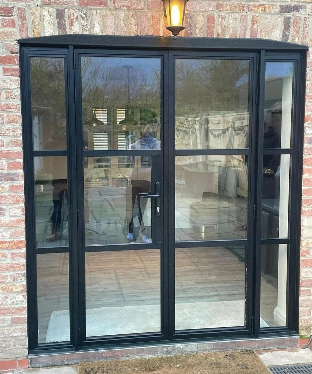 Heritage aluminium single door with side glazing in a brick opening