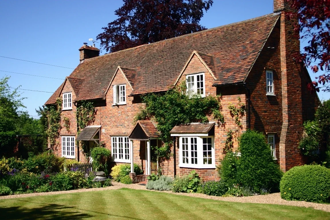 White aluminium windows in a red-brick country cottage