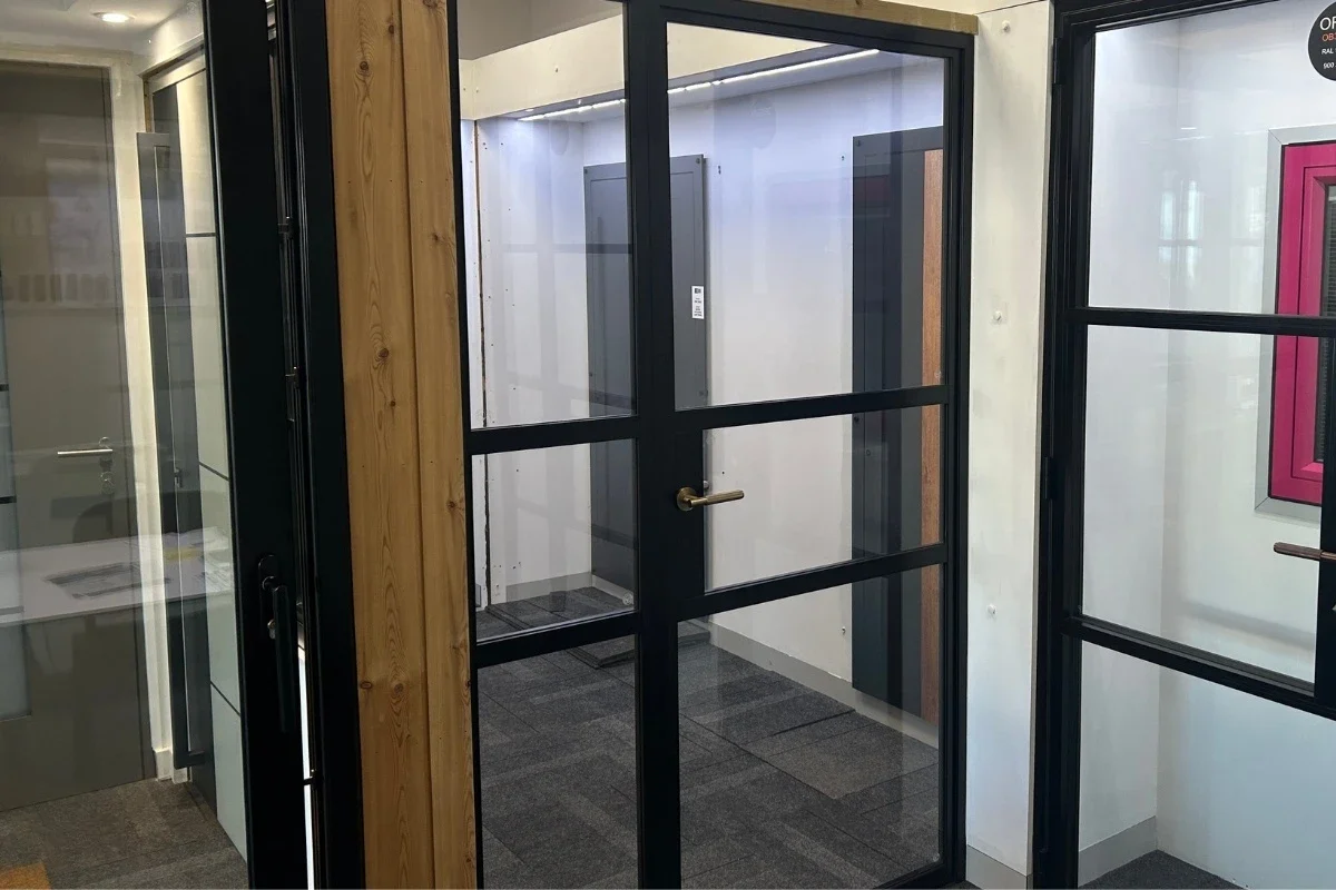 Internal aluminium glazed single door and screen in a showroom