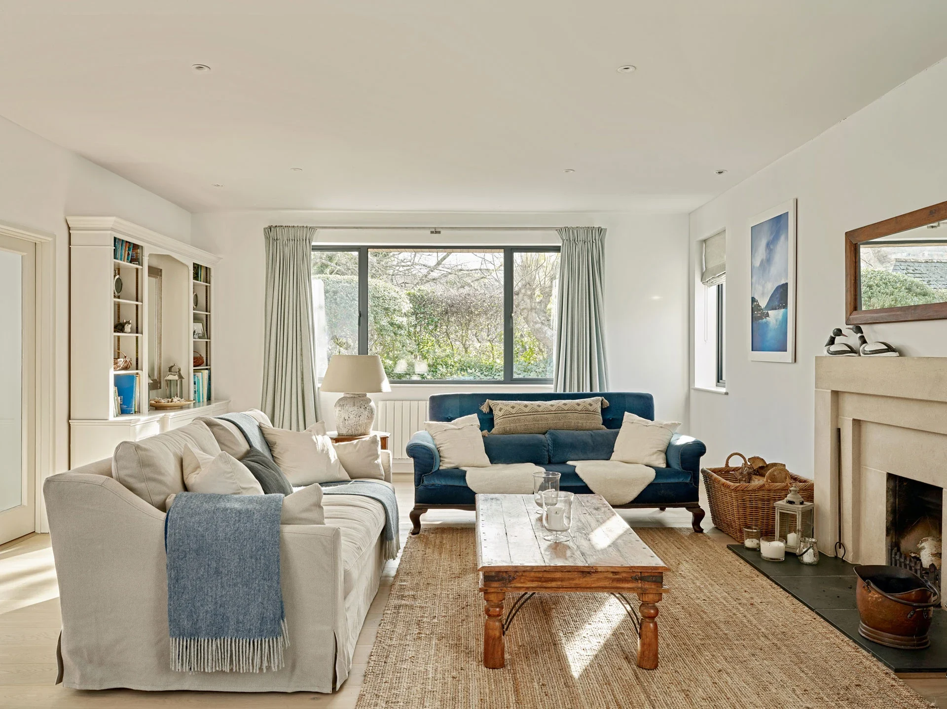 Flush aluminium windows bringing daylight into a furnished living room
