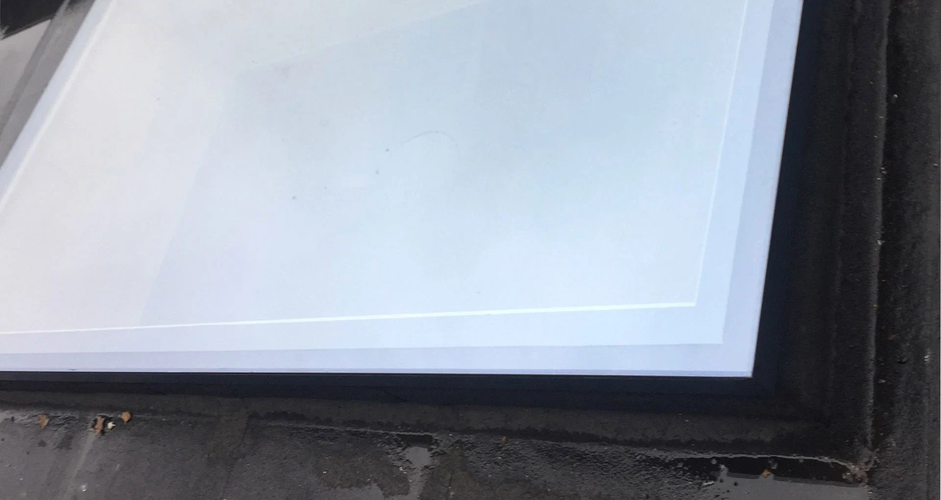 Close-up of the frame and glass of an opening flat rooflight