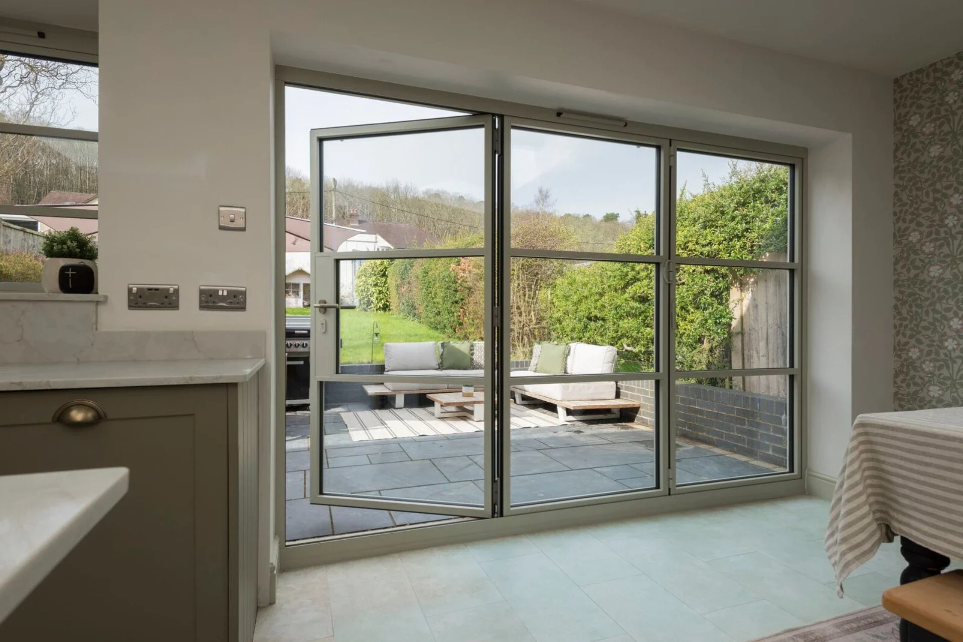 Grey heritage bifold doors beside a kitchen island