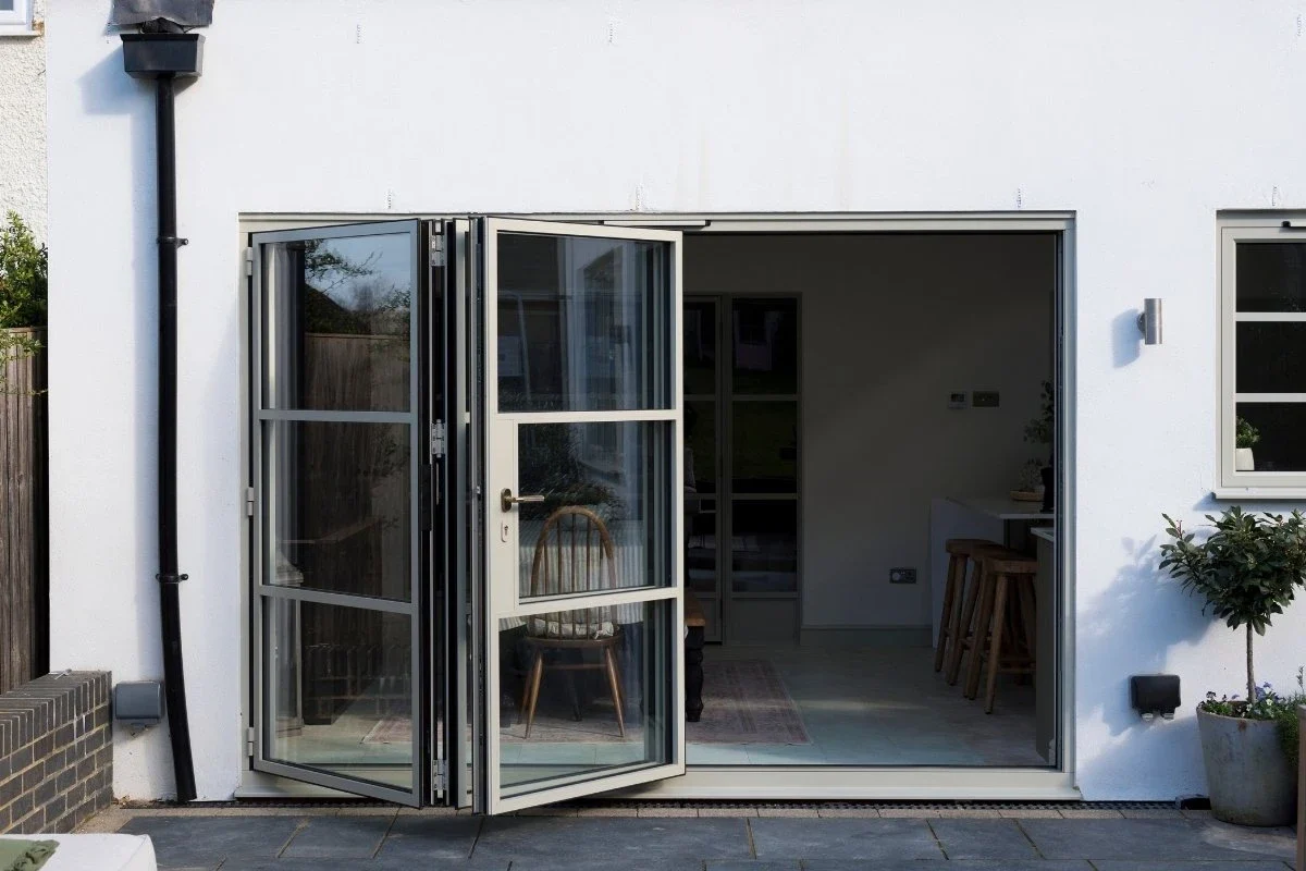 Heritage aluminium bifold doors folded open to the garden