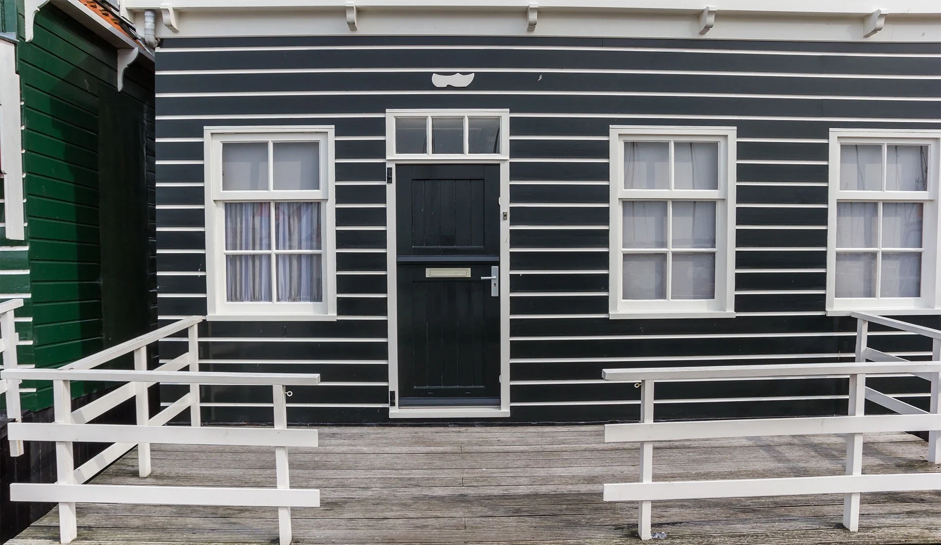 Dark uPVC stable door on a timber-clad property