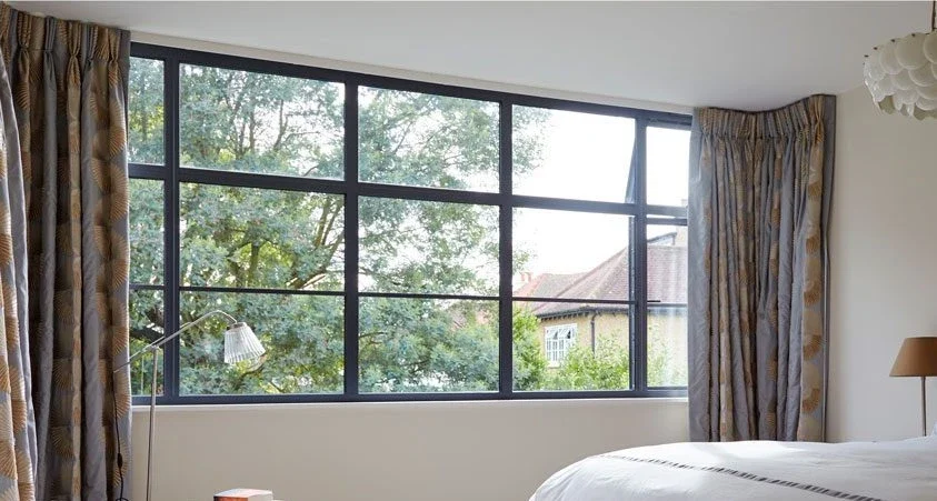 Heritage aluminium window with horizontal glazing bars seen from a bedroom