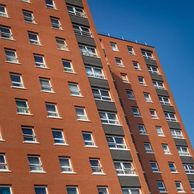 White fully reversible uPVC windows on an apartment building