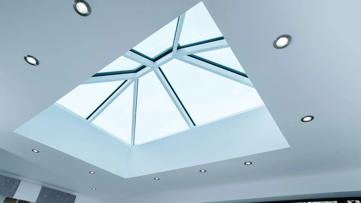 White internal roof lantern frame above a bright extension