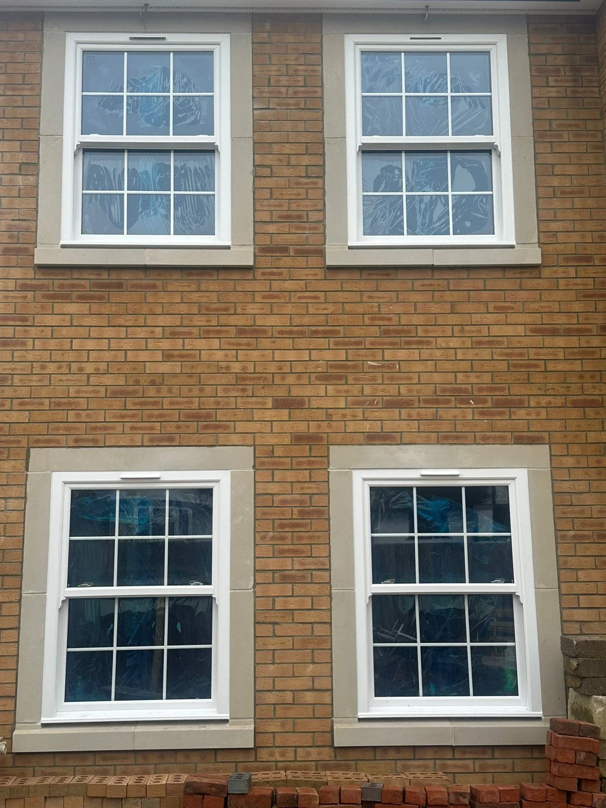 White uPVC sliding sash windows with Georgian bars