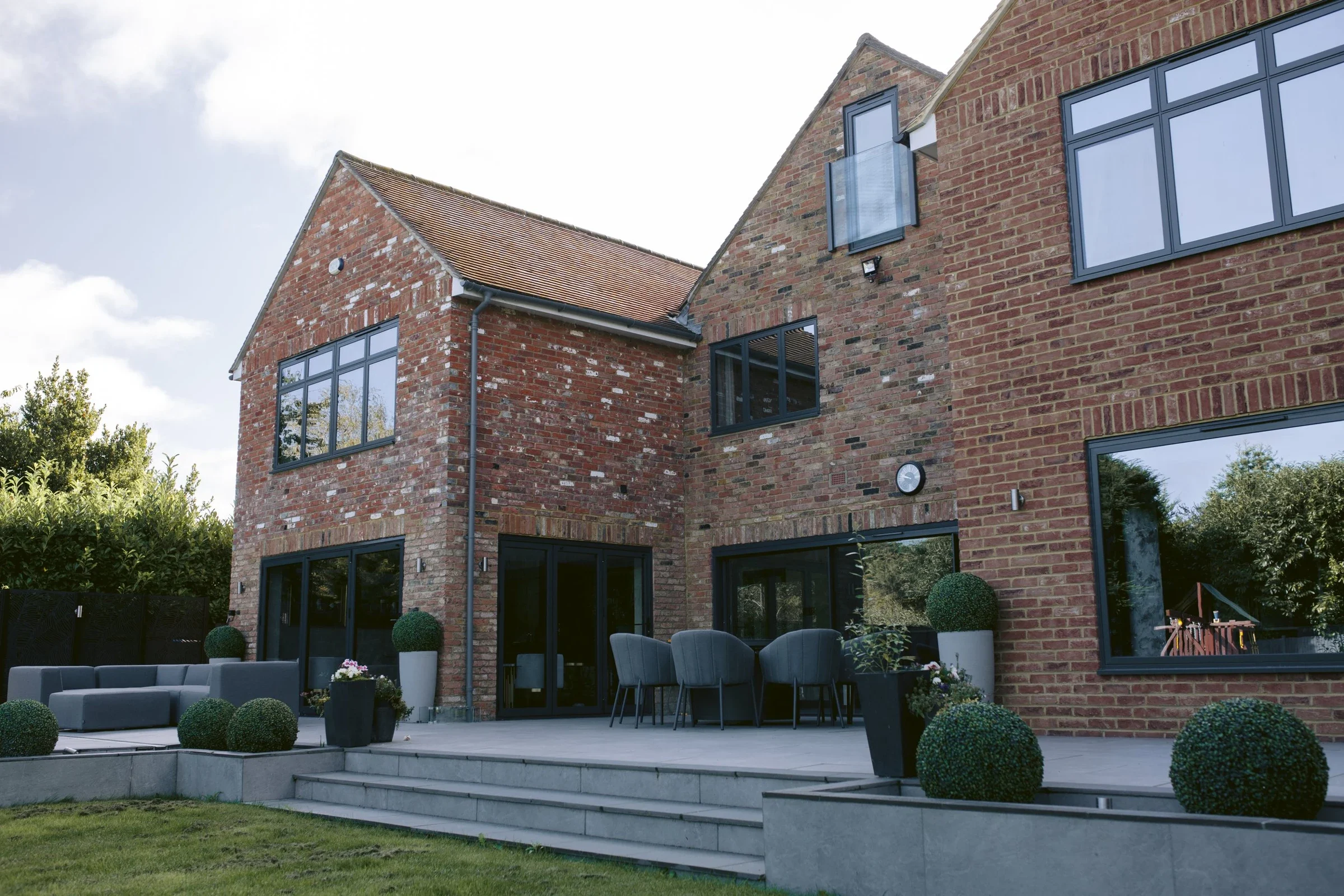 Modern brick house with large aluminium windows and doors