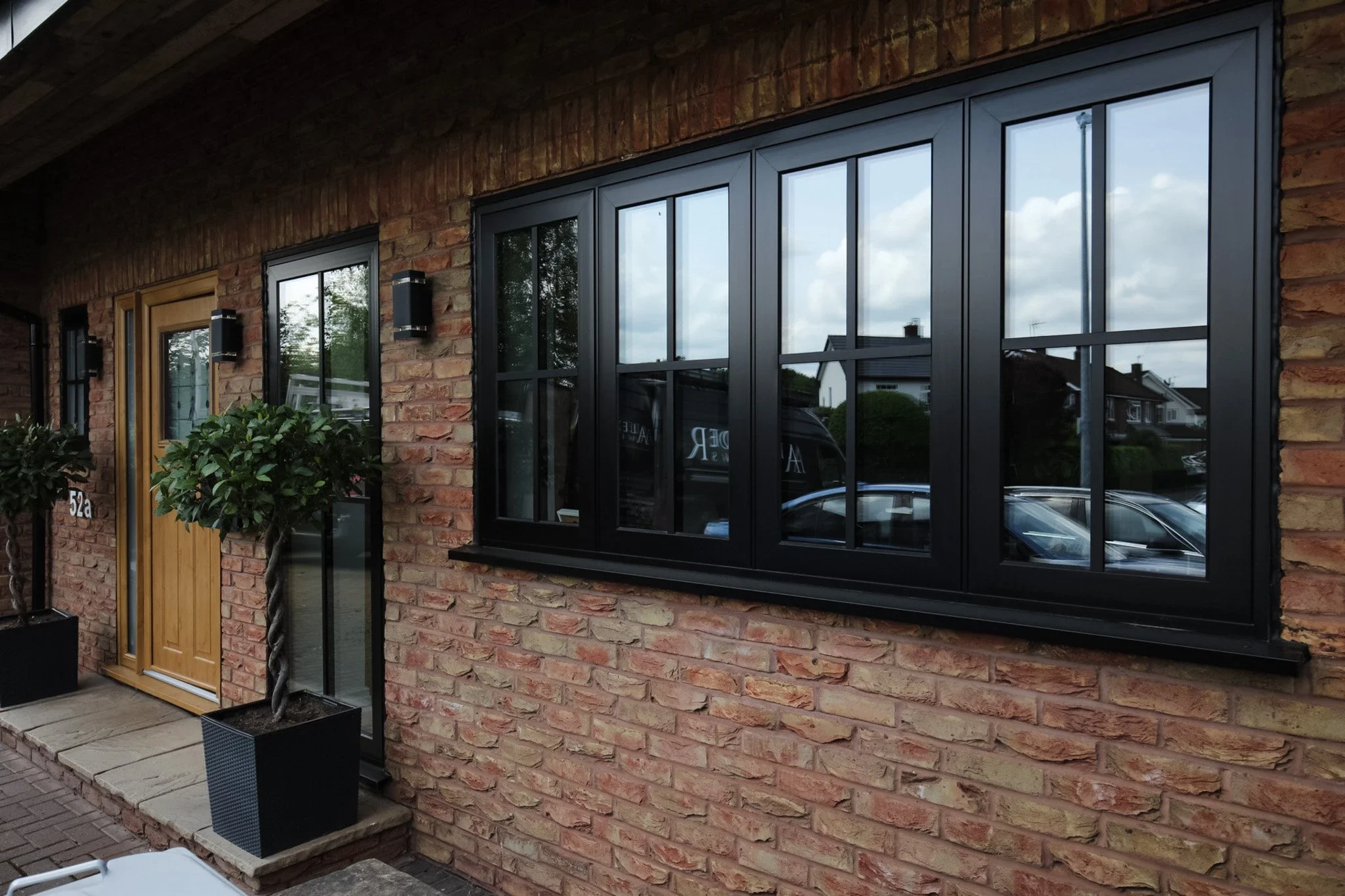 Black flush aluminium windows in a contemporary brick house