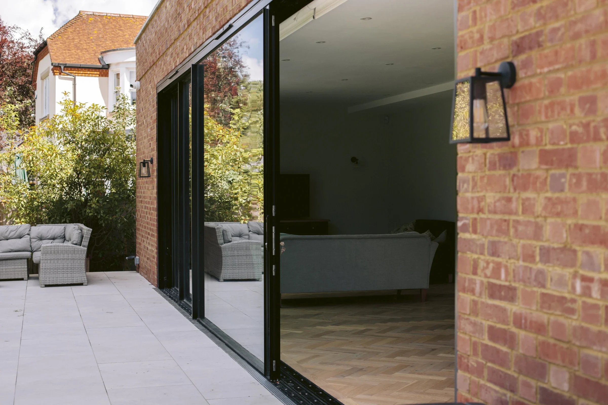 Glass aluminium sliding doors, with a view into a living room 