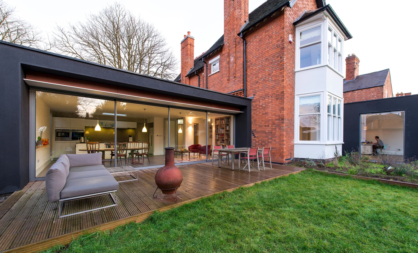 Aluminium sliding doors across a brick-house garden extension
