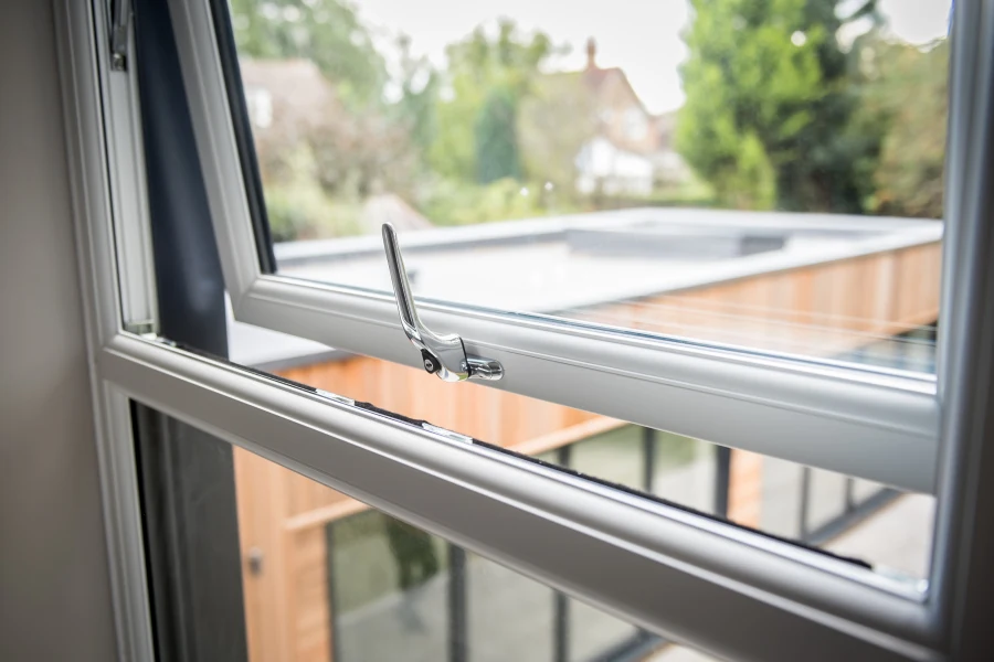 Open grey uPVC casement window viewed from inside a home