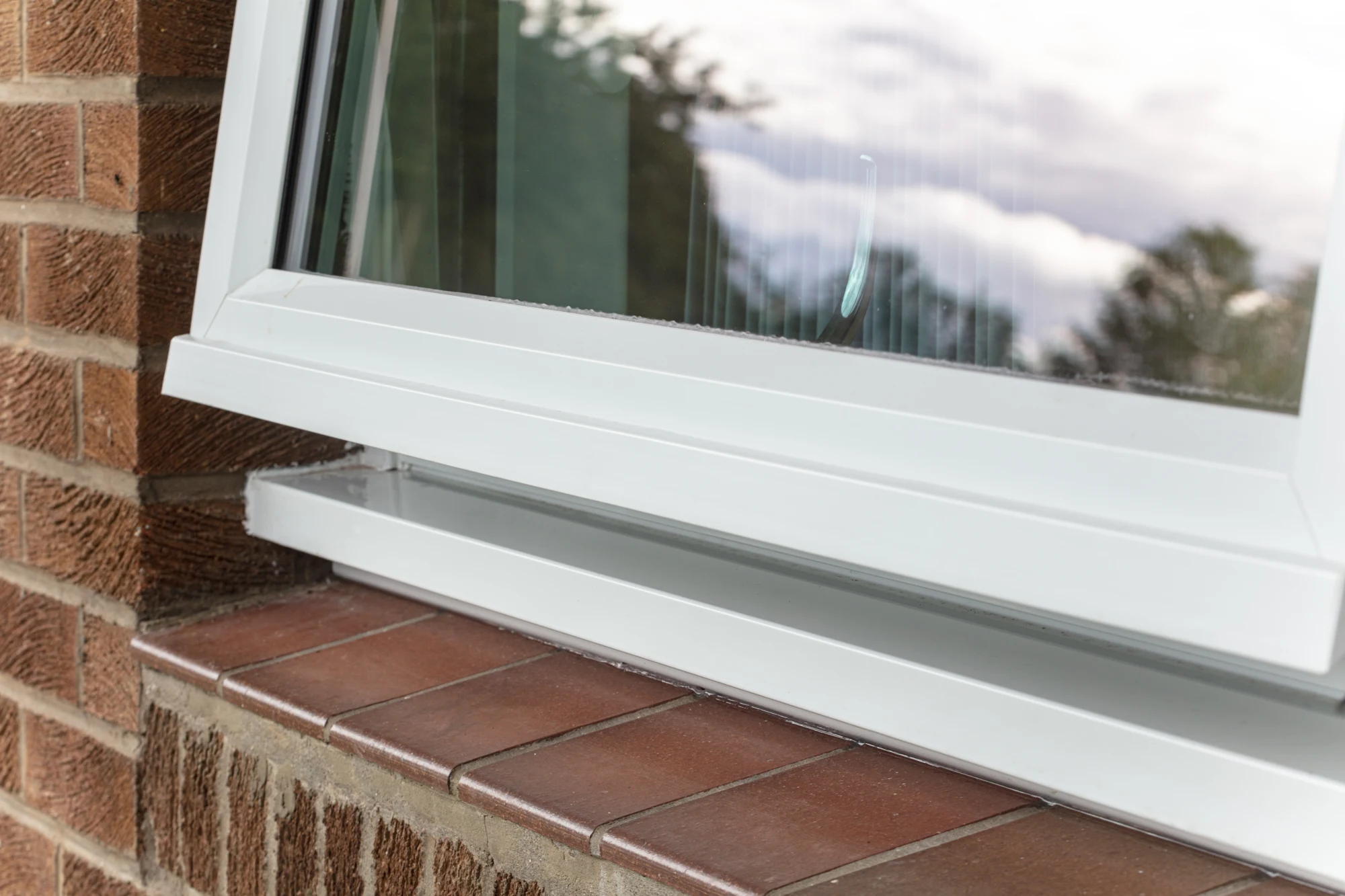 White uPVC reversible window open in a brick-built UK school