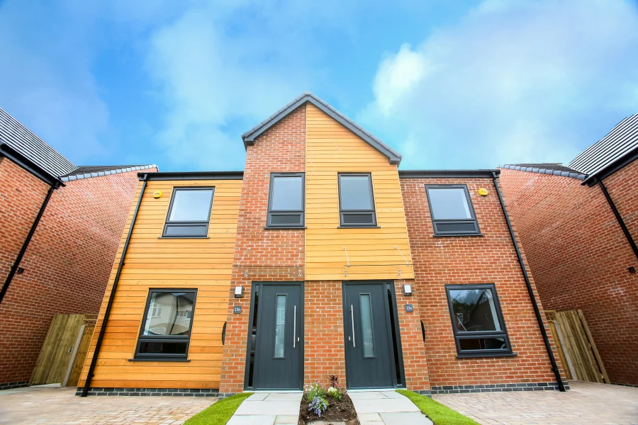 Contemporary British brick and timber-clad home with grey uPVC windows